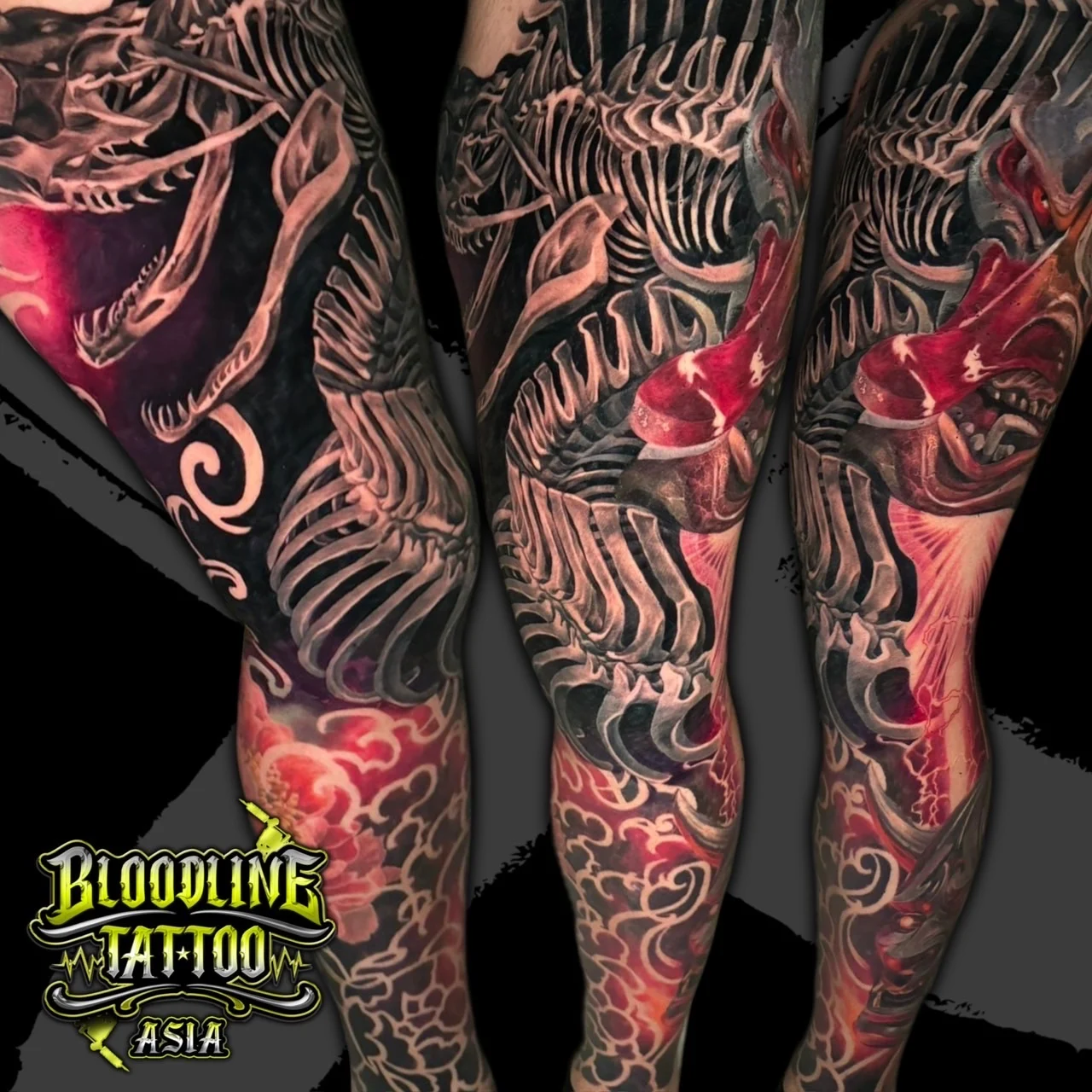 Colour dark surreal full leg sleeve tattoo with skeletal figures, skulls, and glowing red and pink energy patterns at Bloodline Tattoo Bangkok.