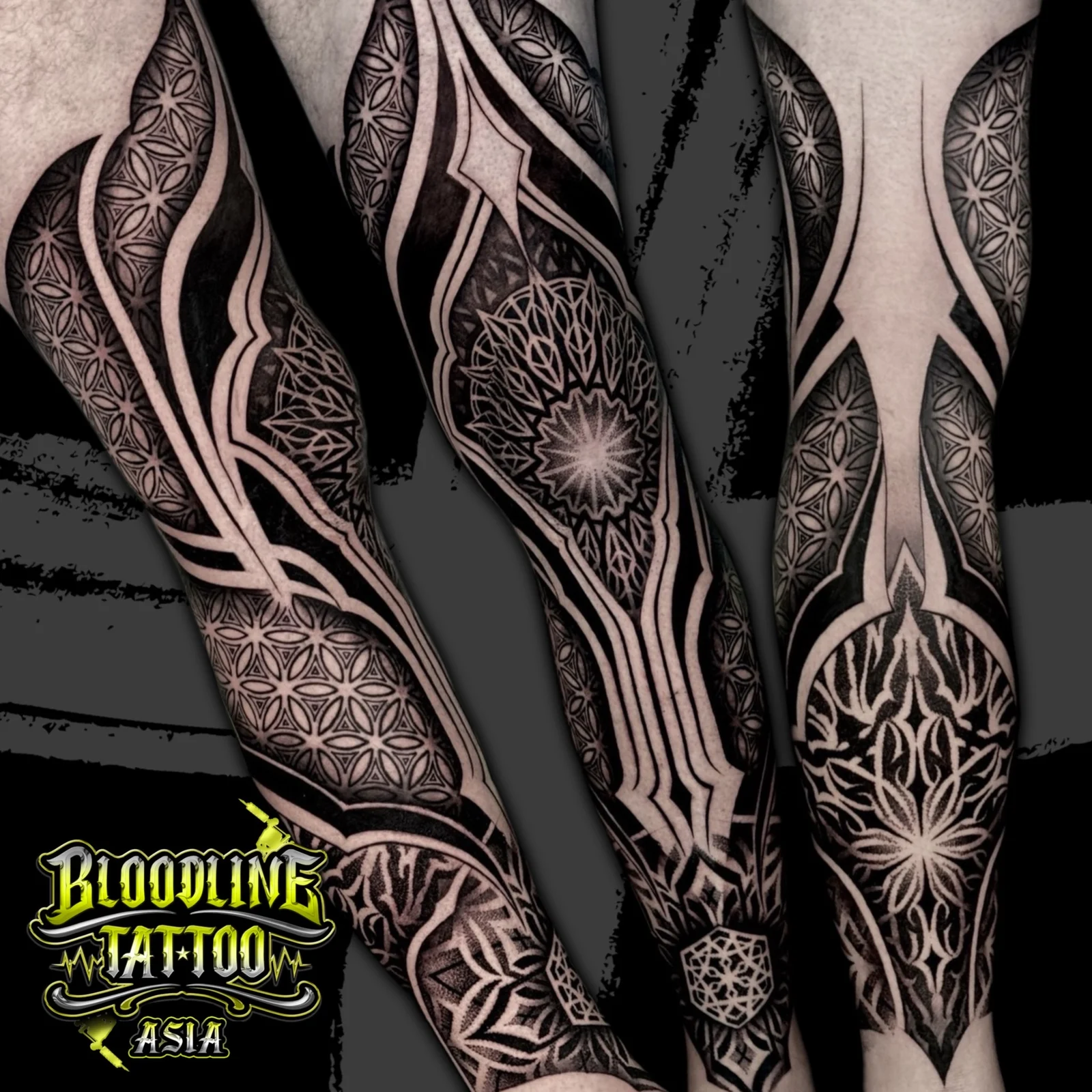 Triptych full-leg tattoo with Flower of Life panels, central lower-leg mandala, and architectural dotwork pathways, at Bloodline Tattoo Bangkok.