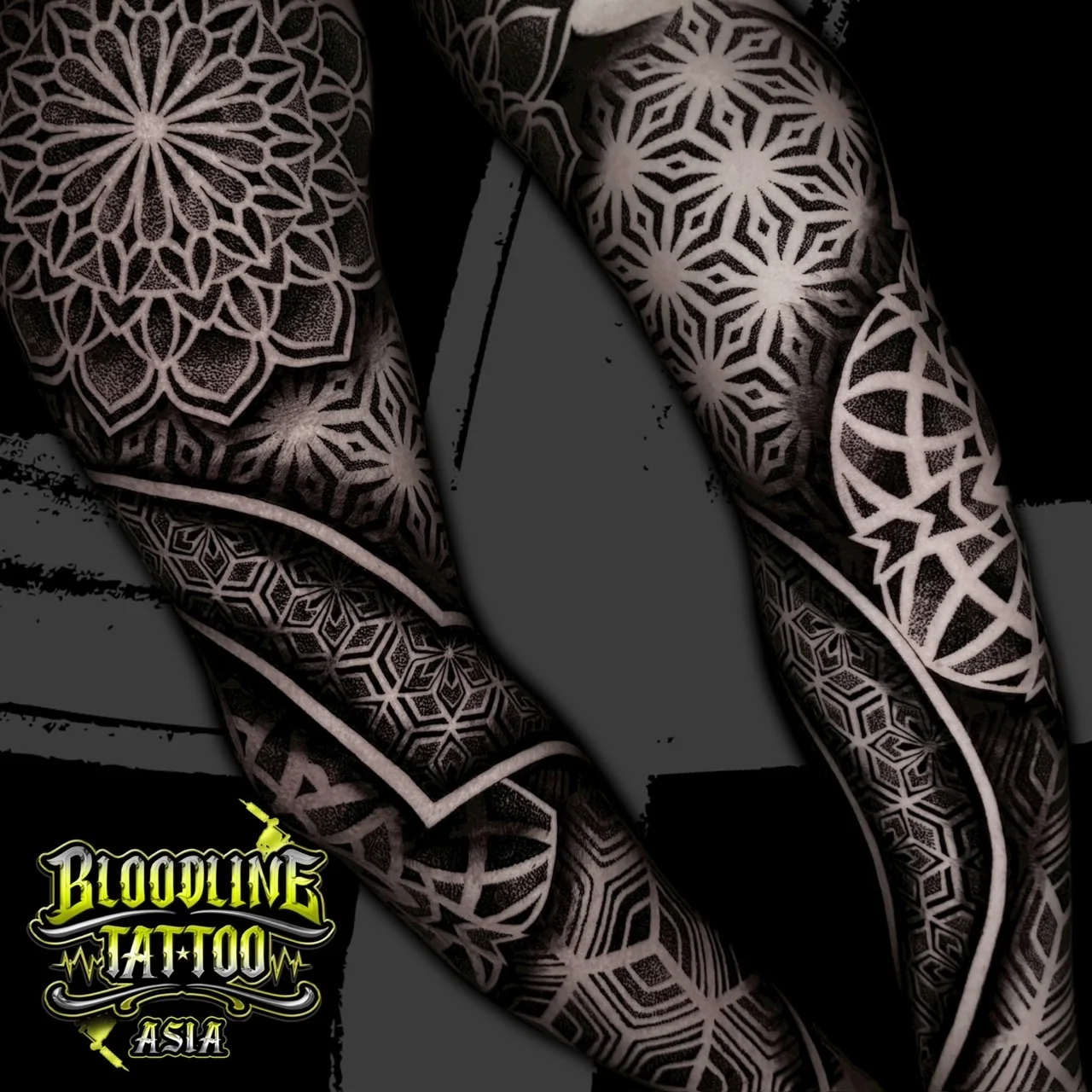 Full sleeve with shoulder mandala, negative-space bands, and interlocking 3D cube and hex dotwork patterns, at Bloodline Tattoo Bangkok.