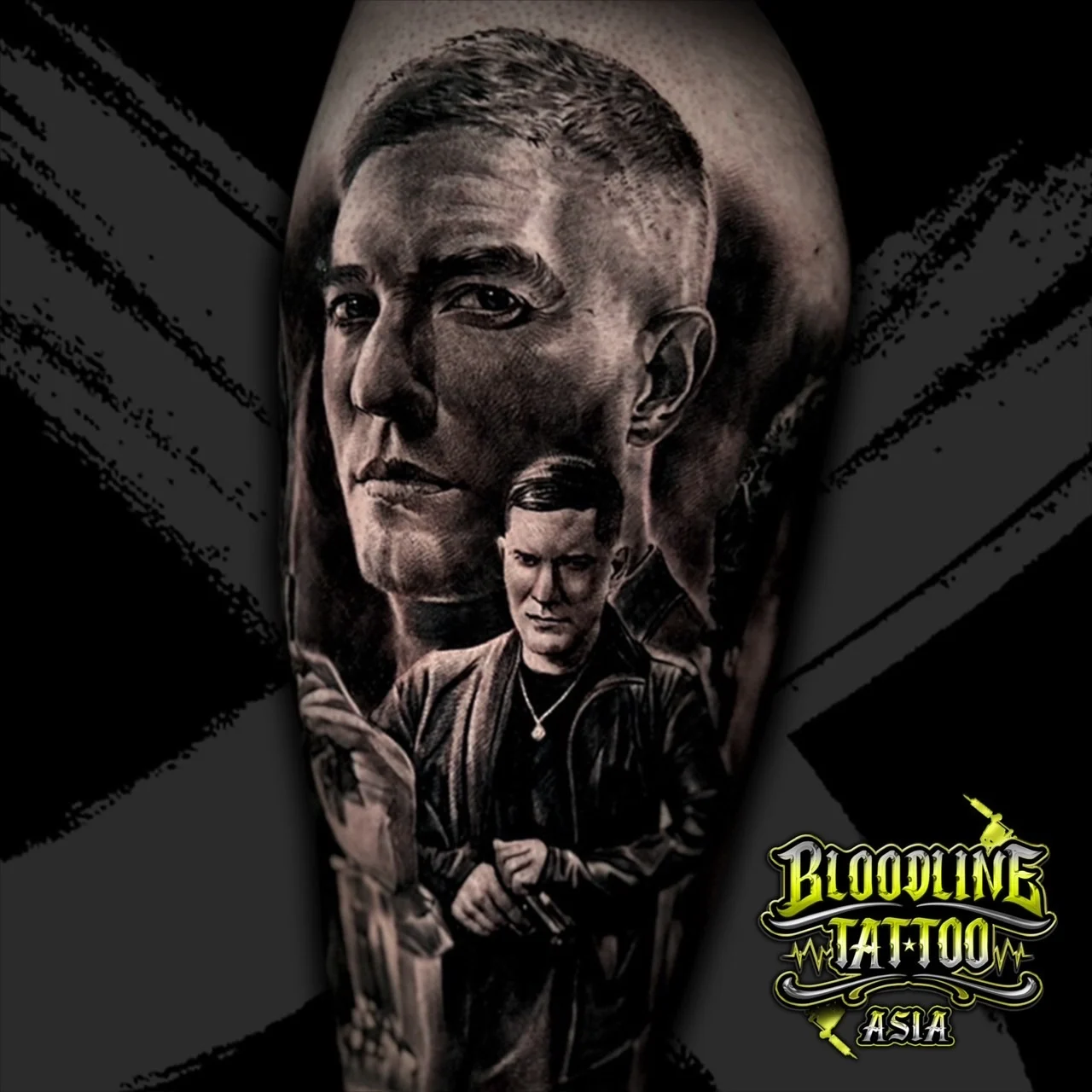 Black and grey portrait realism upper arm tattoo of Tommy Egan from Power with close-up face and leather jacket figure holding a handgun at Bloodline Tattoo Bangkok.